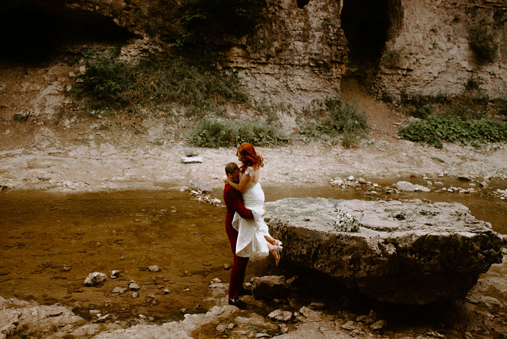 elora mill hotel elopement bride and groom walk through the victoria park gorge as husband and wife