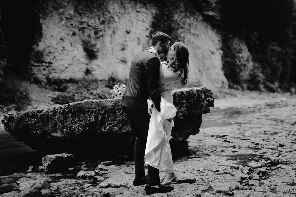 elora mill hotel elopement bride and groom walk through the victoria park gorge as husband and wife