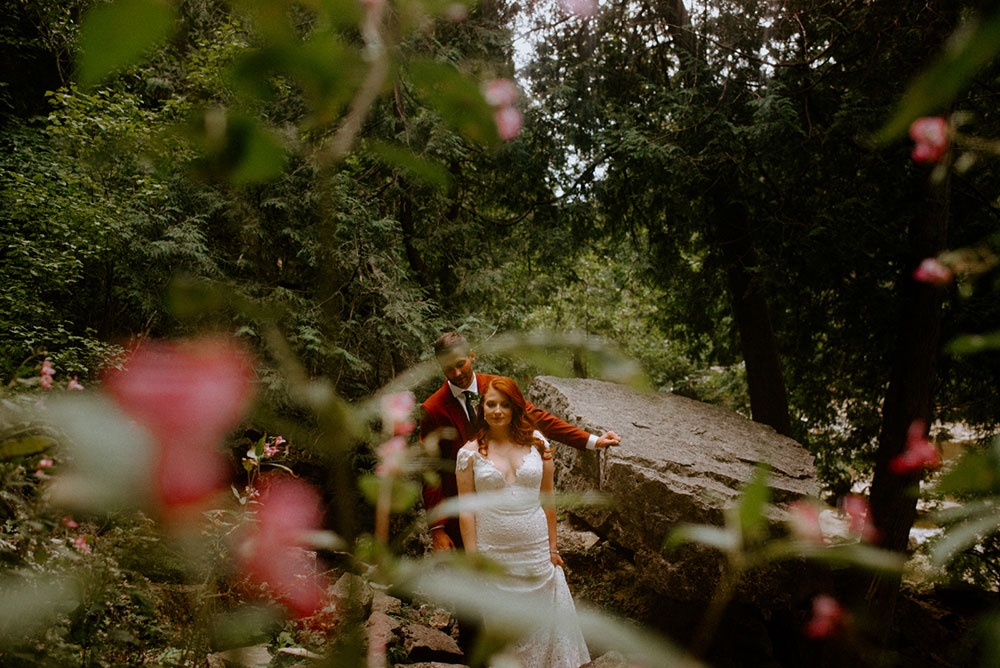 elora mill hotel elopement bride and groom walk through the victoria park gorge as husband and wife