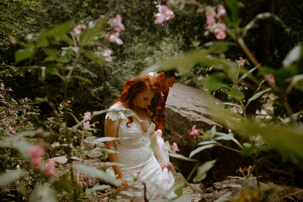 elora mill hotel elopement bride and groom walk through the victoria park gorge as husband and wife