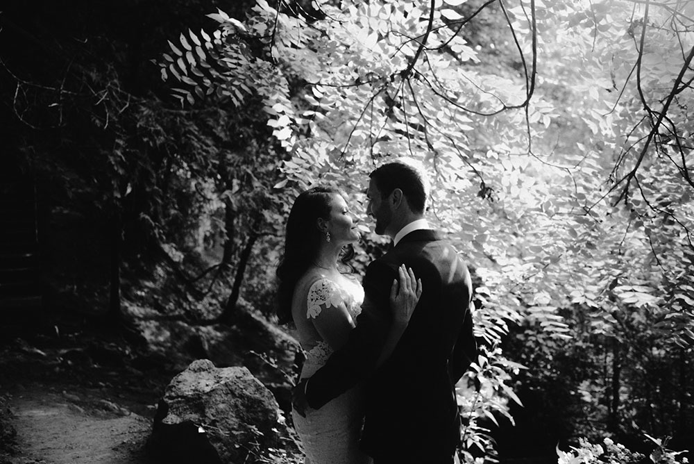 elora mill hotel elopement bride and groom walk through the victoria park gorge as husband and wife