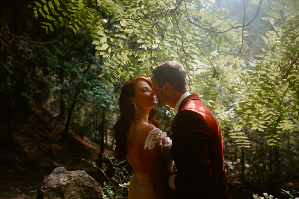 elora mill hotel elopement bride and groom walk through the victoria park gorge as husband and wife