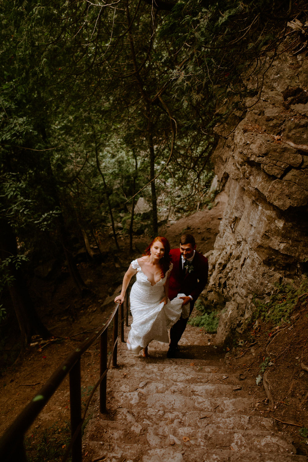 elora mill hotel elopement bride and groom walk through the victoria park gorge as husband and wife