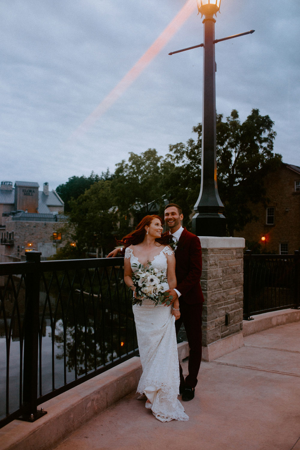 elora mill hotel elopement bride and groom dance through the downtown as husband and wife