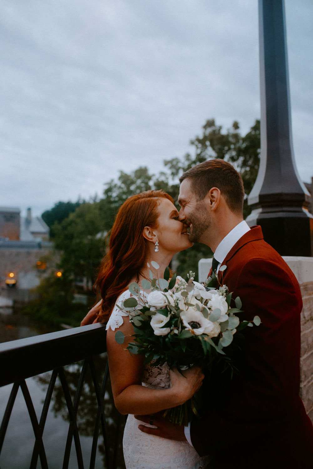 elora mill hotel elopement bride and groom dance through the downtown as husband and wife