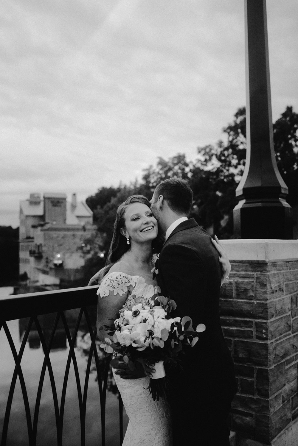 elora mill hotel elopement bride and groom dance through the downtown as husband and wife