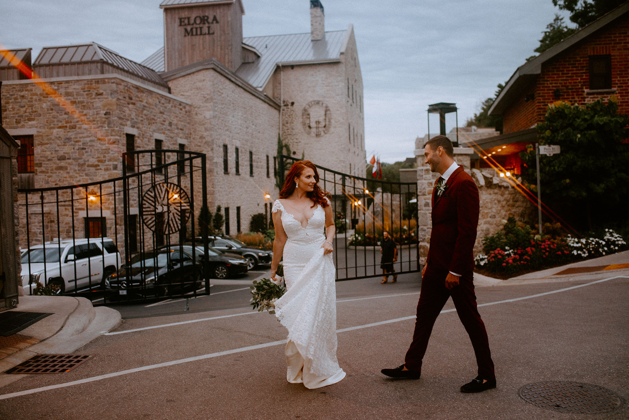 elora mill elopement bride and groom dance in front of the elora mill hotel