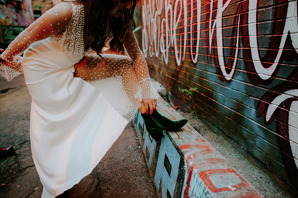 The Burroughes Toronto Wedding Couple candidly run around Graffiti Alley in Toronto