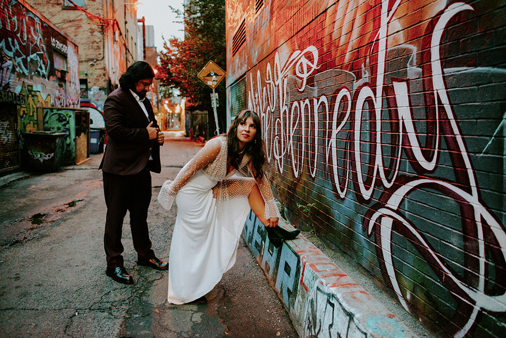 The Burroughes Toronto Wedding Couple candidly run around Graffiti Alley in Toronto