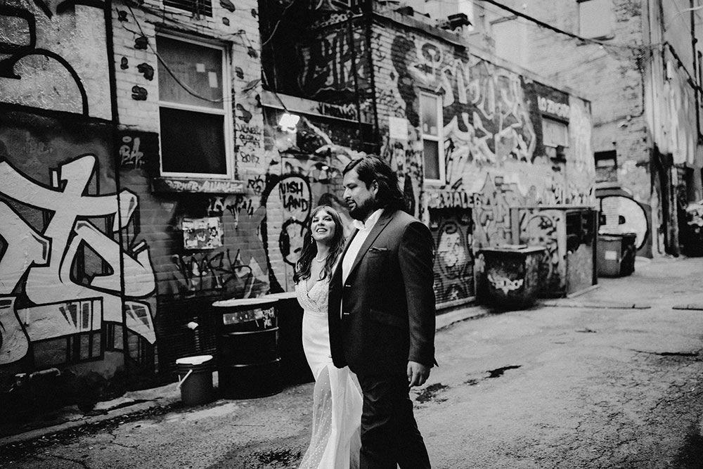 The Burroughes Toronto Wedding Couple candidly run around Graffiti Alley in Toronto