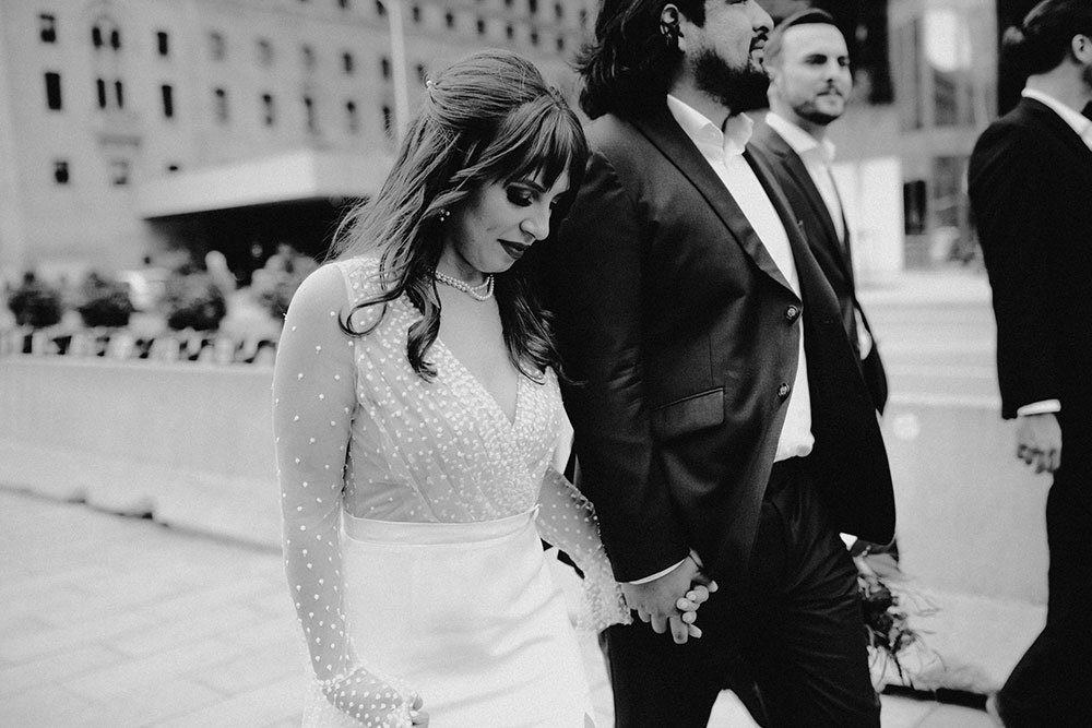 The Burroughes Toronto Wedding Couple walk candidly with each other at Union Station