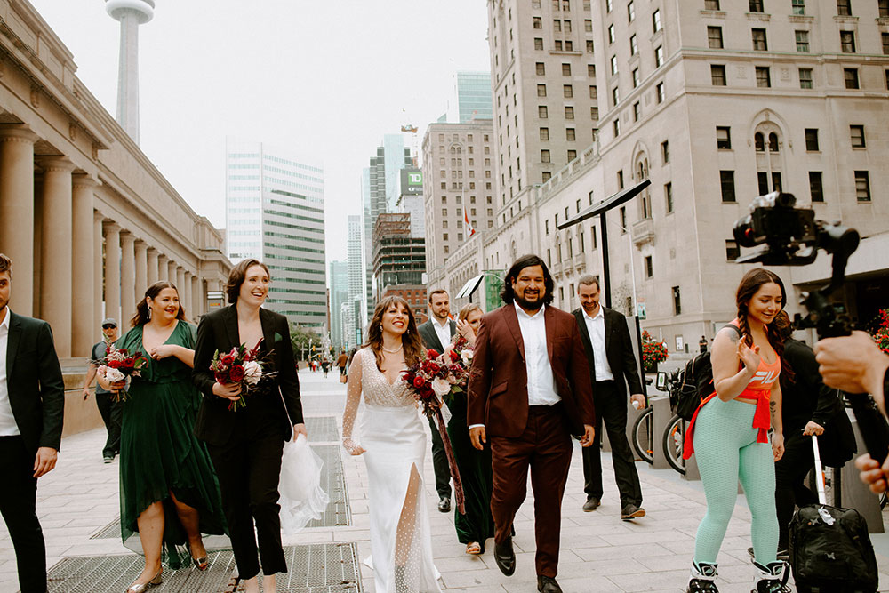 The Burroughes Toronto Wedding couple walk hand in hand at union station