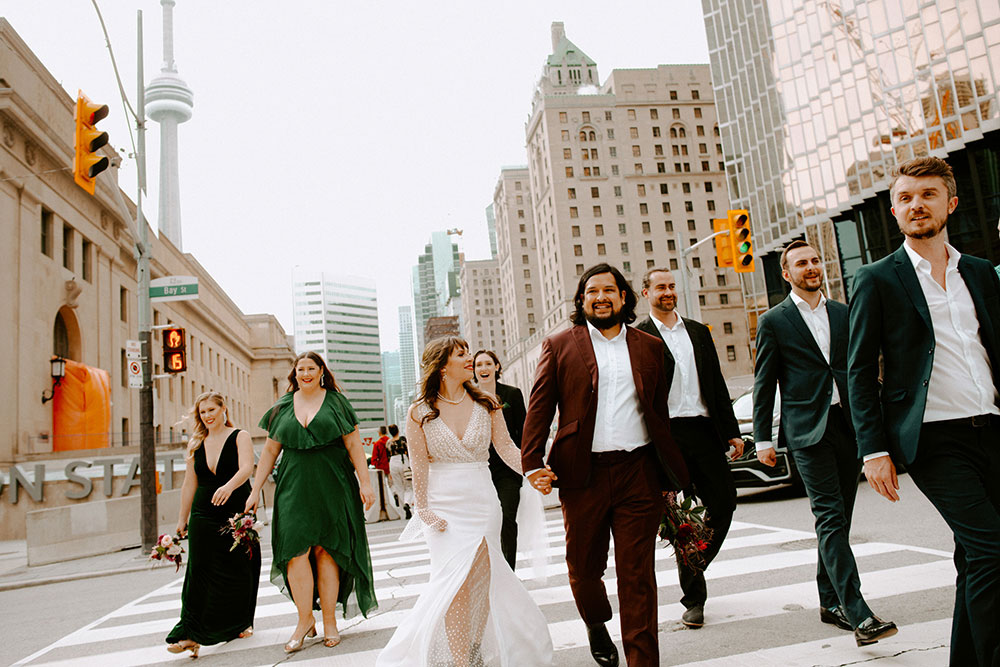 The Burroughes Toronto Wedding Couple cross street after passing Union station