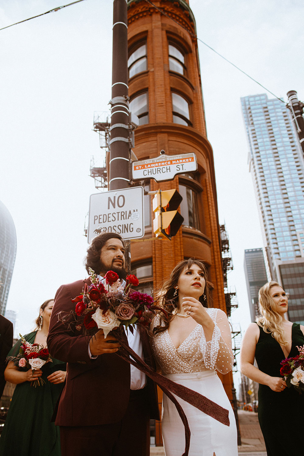 The Burroughes Toronto Wedding Party stand in front of the Gooderham Building in Toronto