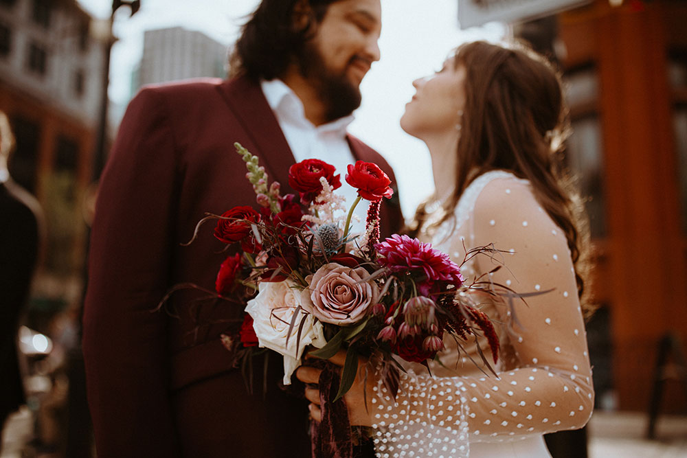 The Burroughes Toronto Wedding Party stand in front of the Gooderham Building in Toronto