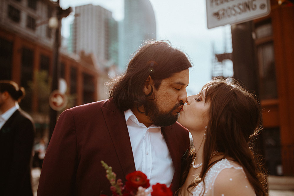 The Burroughes Toronto Wedding Party stand in front of the Gooderham Building in Toronto