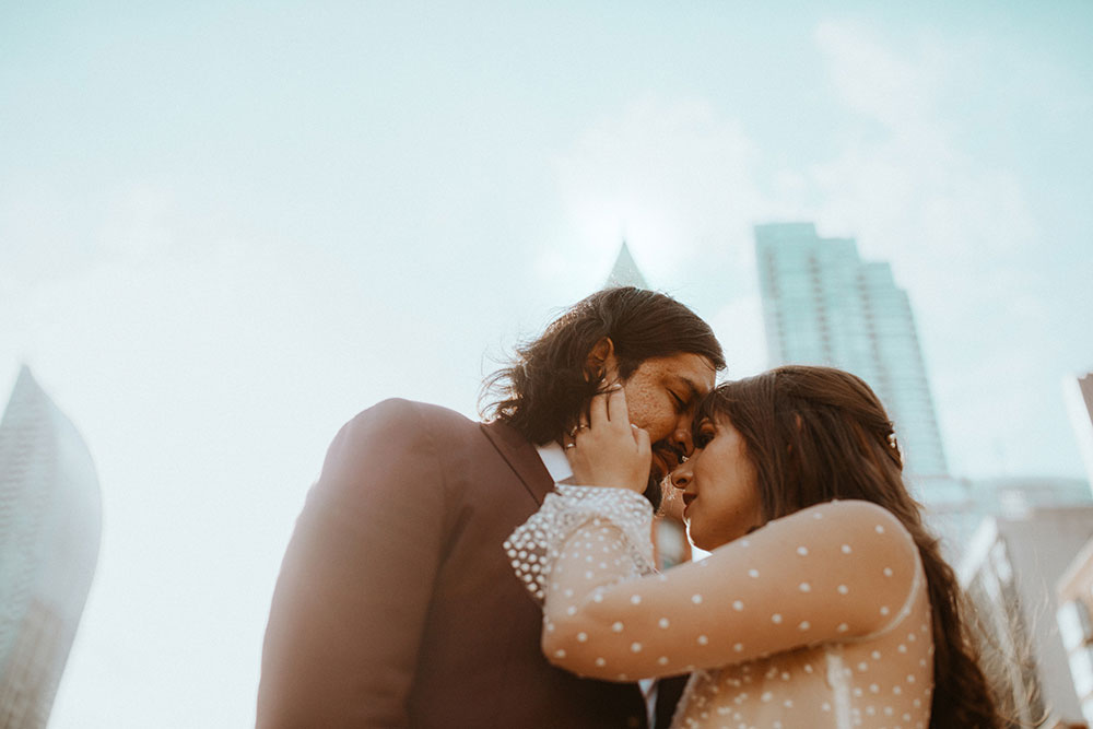 The Burroughes Toronto Wedding Couple stand in front of the Gooderham Building in Toronto