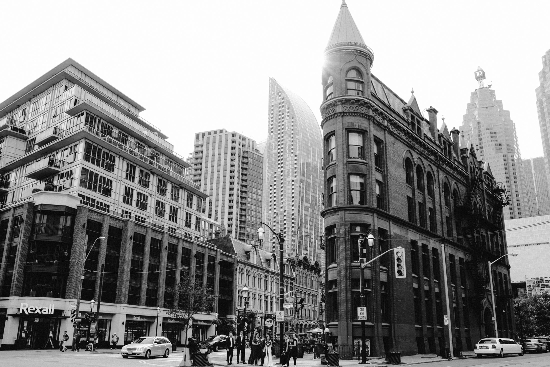 The Burroughes Toronto Wedding Party stand in front of the Gooderham Building in Toronto