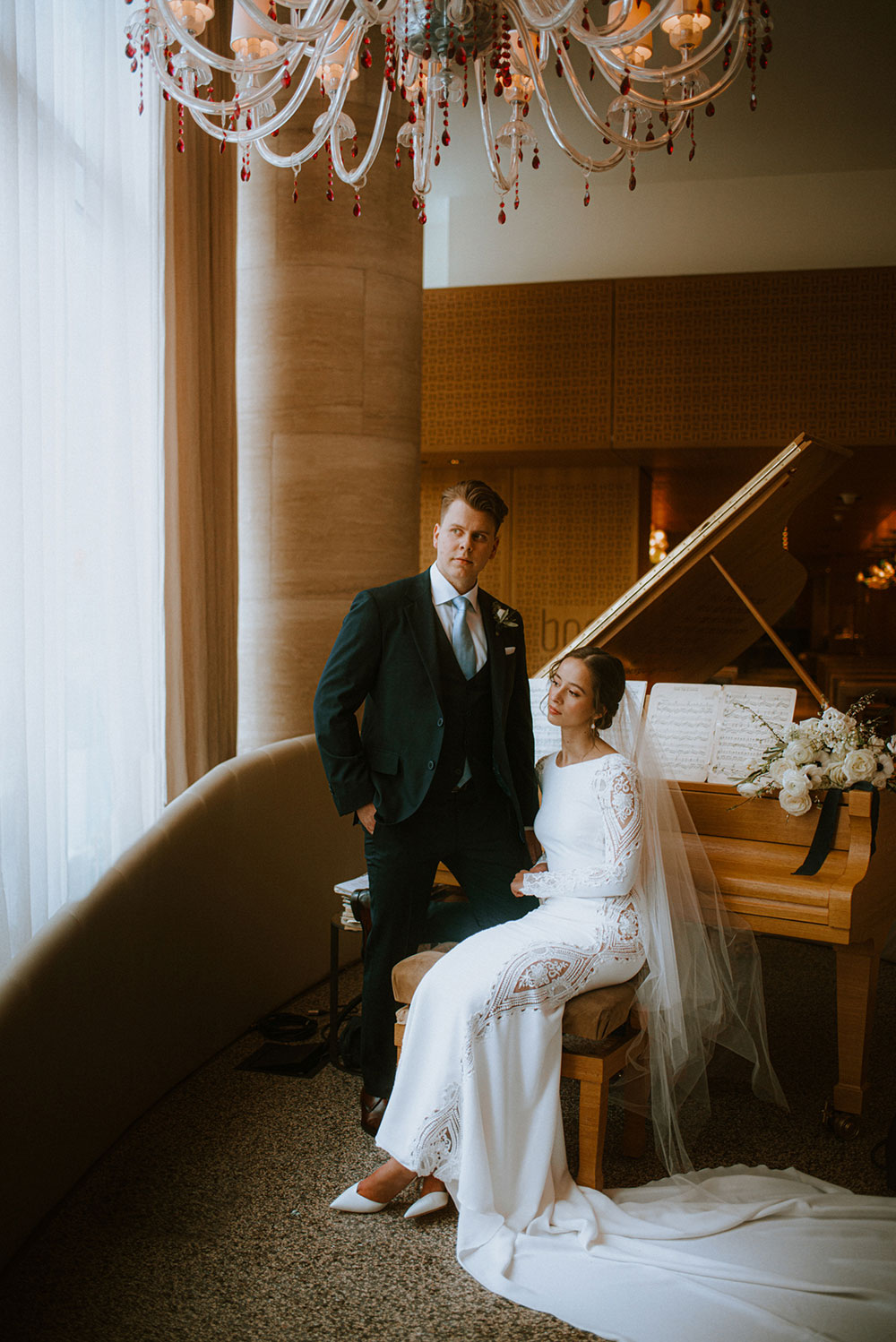 Shangri-La Hotel Toronto Wedding groom & bride sit by piano in hotel lobby