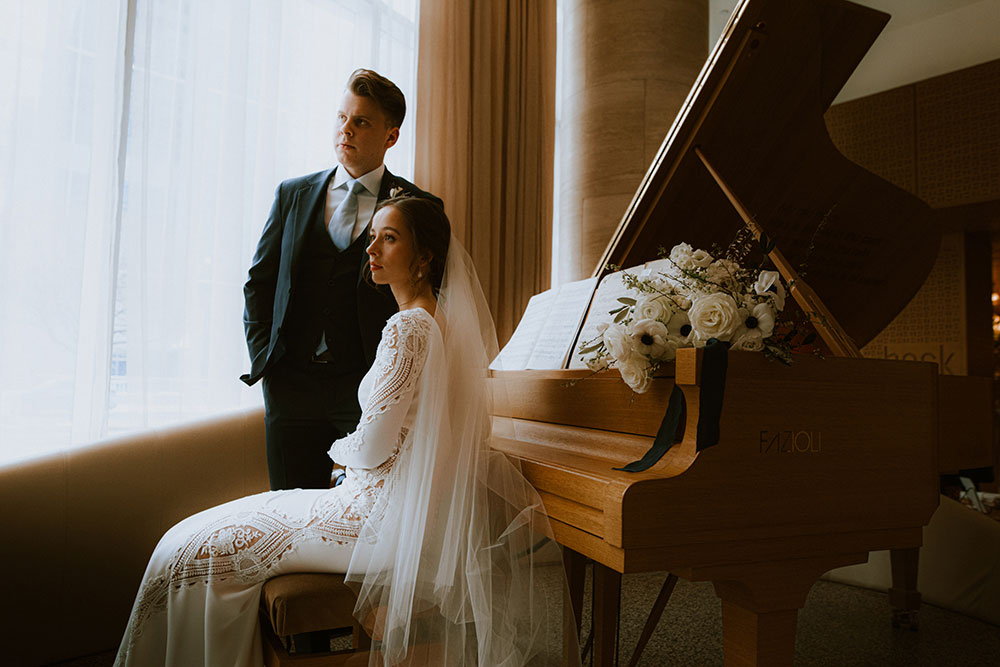 Shangri-La Hotel Toronto Wedding groom & bride sit by piano in hotel lobby