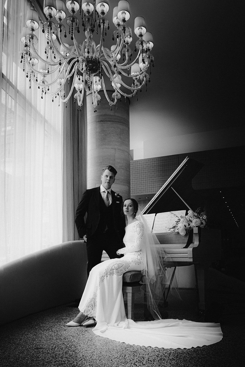 Shangri-La Hotel Toronto Wedding groom & bride sit by piano in hotel lobby