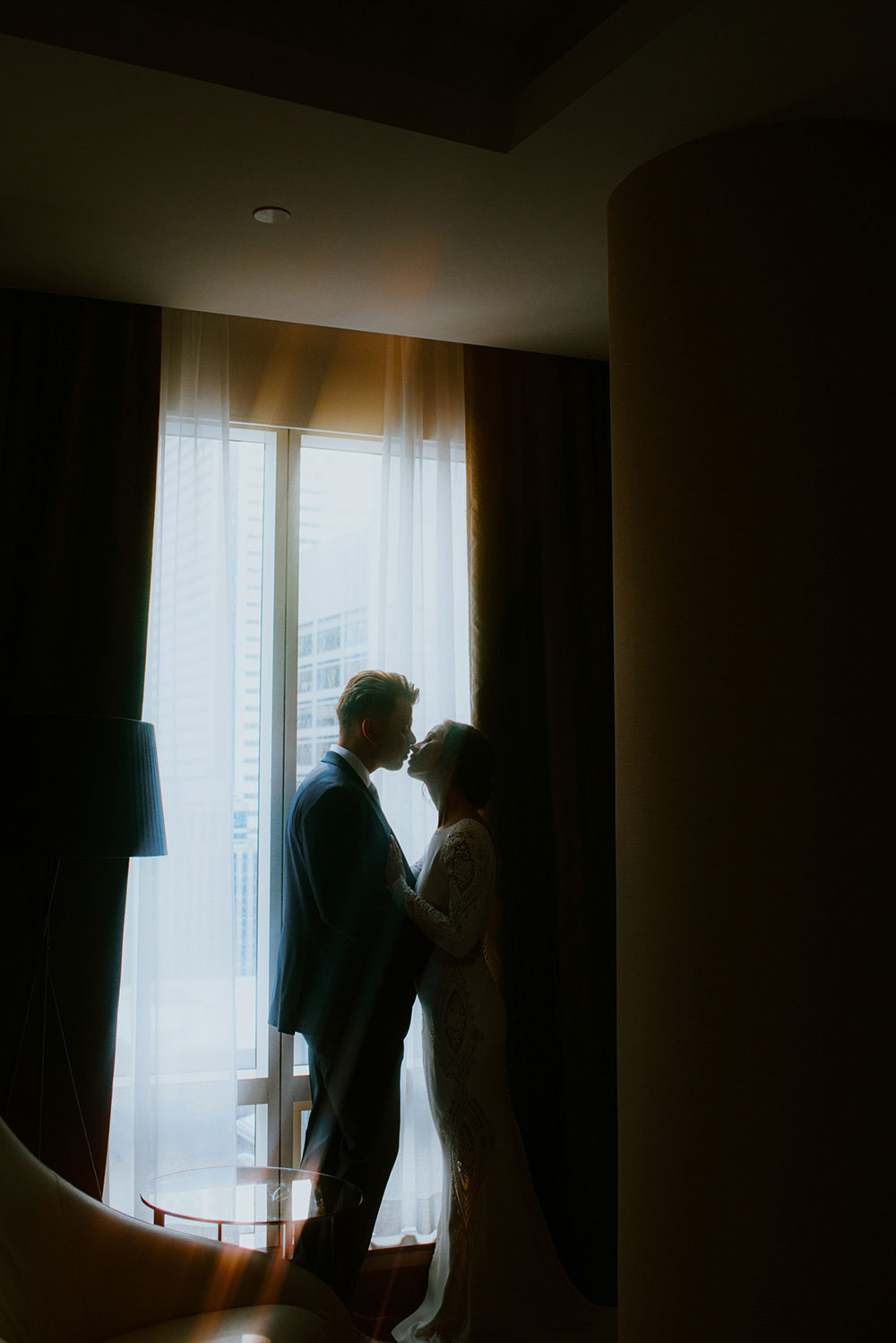 Shangri-La Hotel Toronto Wedding groom & bride stand by window in suite