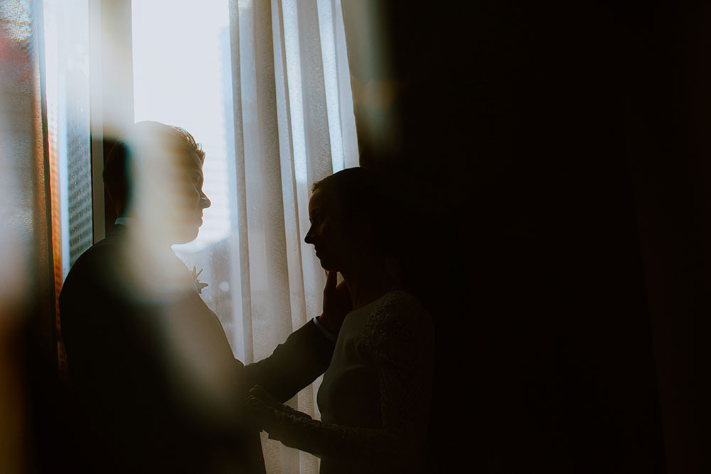 Shangri-La Hotel Toronto Wedding groom & bride stand by window in suite