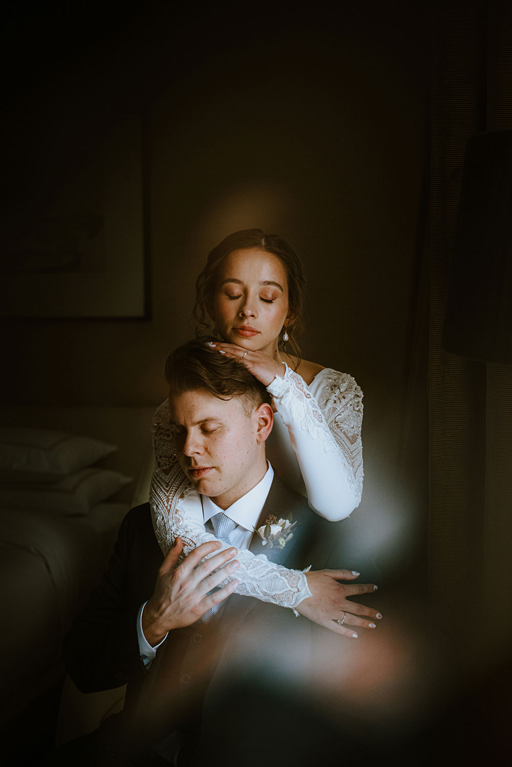 Shangri-La Hotel Toronto Wedding groom & bride embrace in dark room