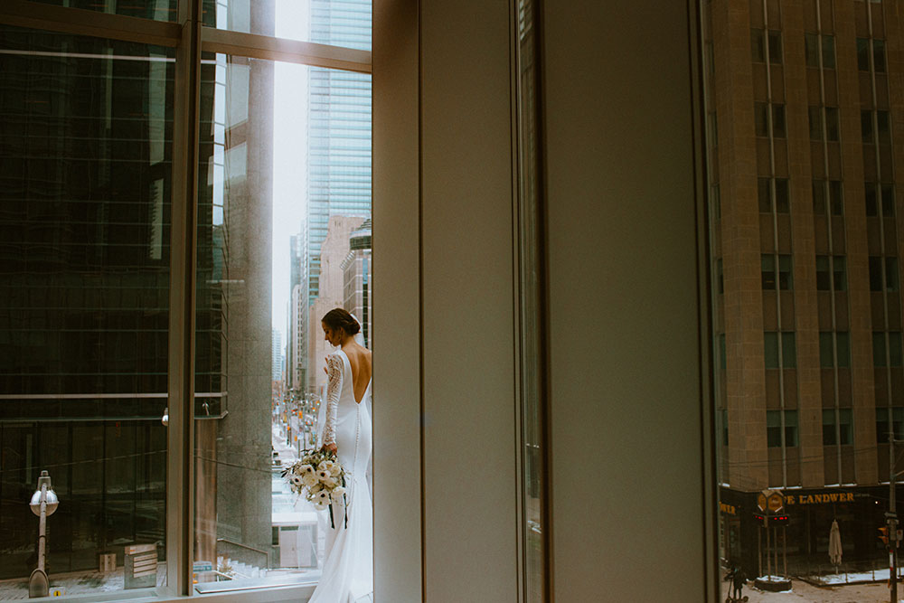 Shangri-La Hotel Toronto Wedding bride poses in museum room