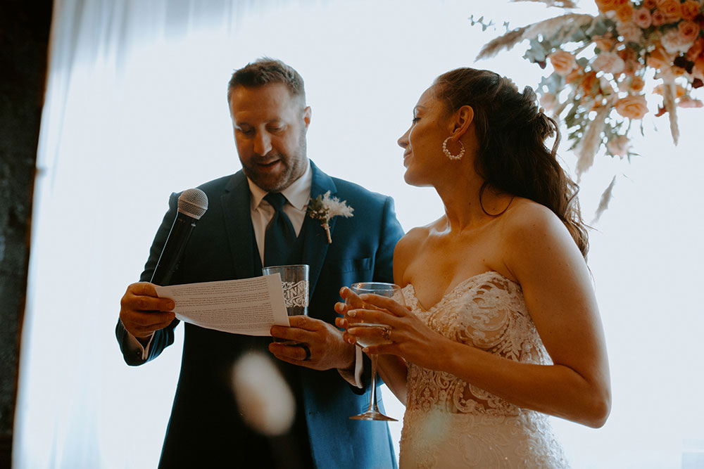 newlyweds give their speech at their wedding reception