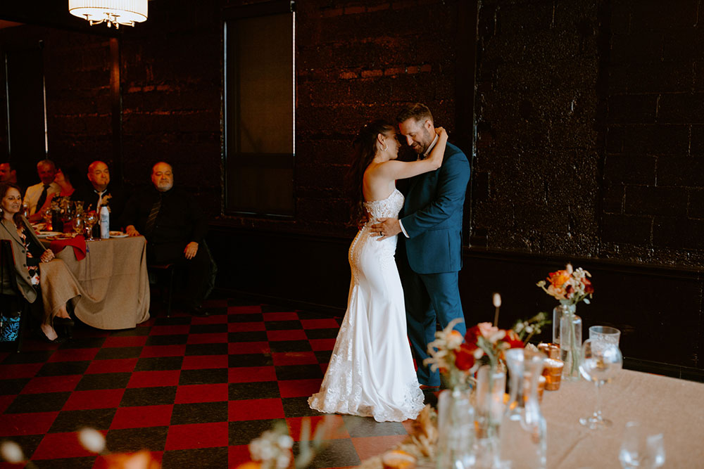 newlyweds first dance at their reception at respect is burning kitchen