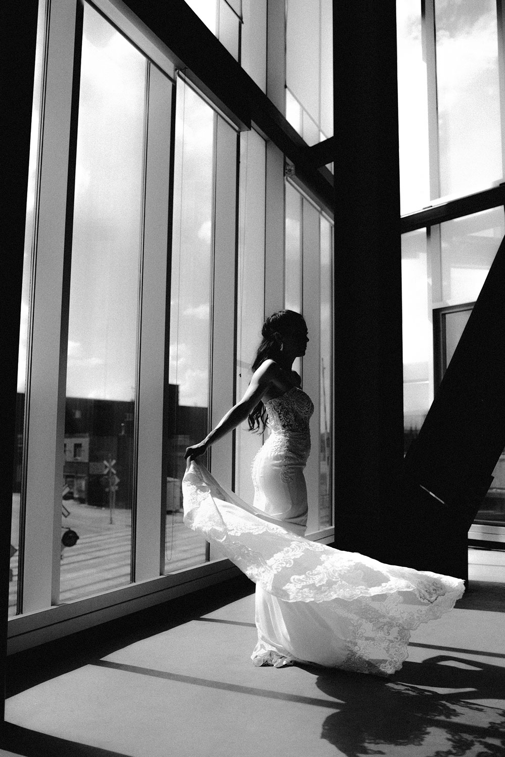 bride twirls in her gown during a portrait session at the school of architecture in sudbury