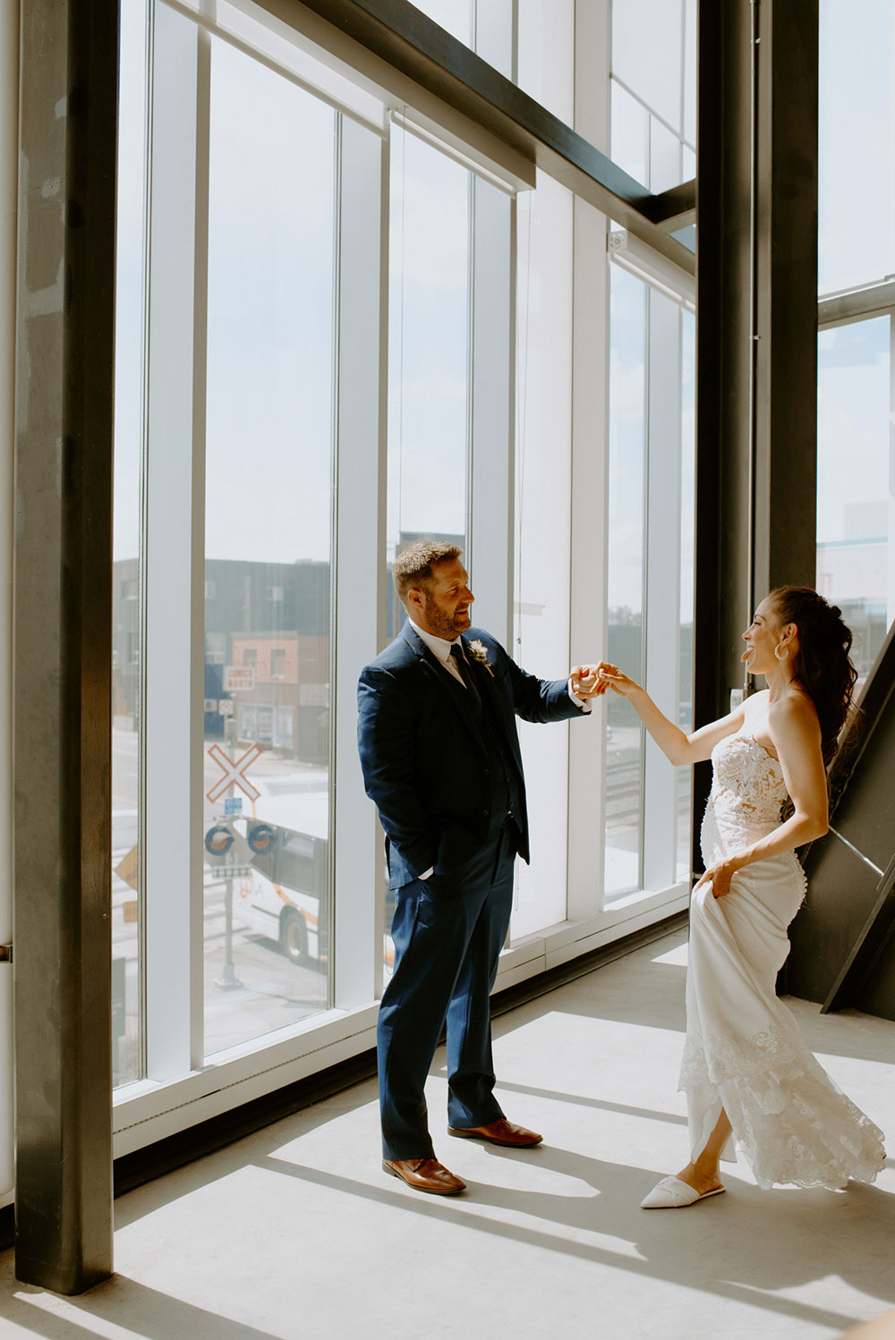 newlyweds dance during their portrait session at the school of architecture in sudbury