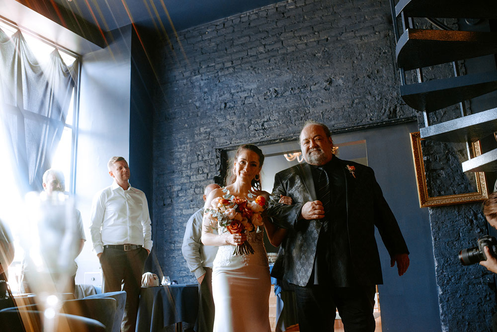 father walks his daughter down the aisle for the ceremony at the cedar nest in sudbury 
 