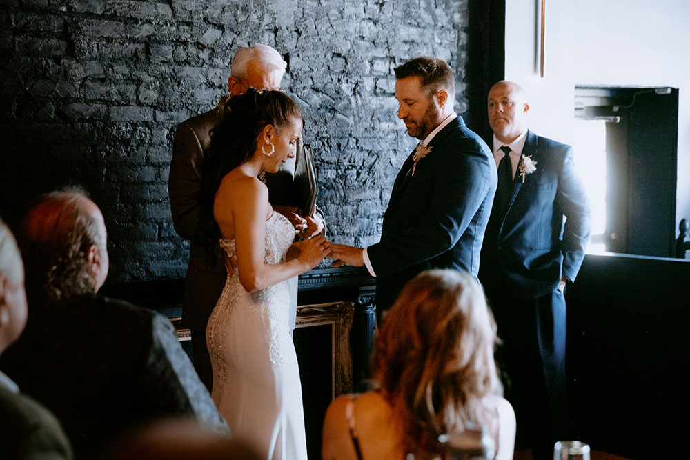 couple exchange rings during the ceremony at the cedar nest in Sudbury