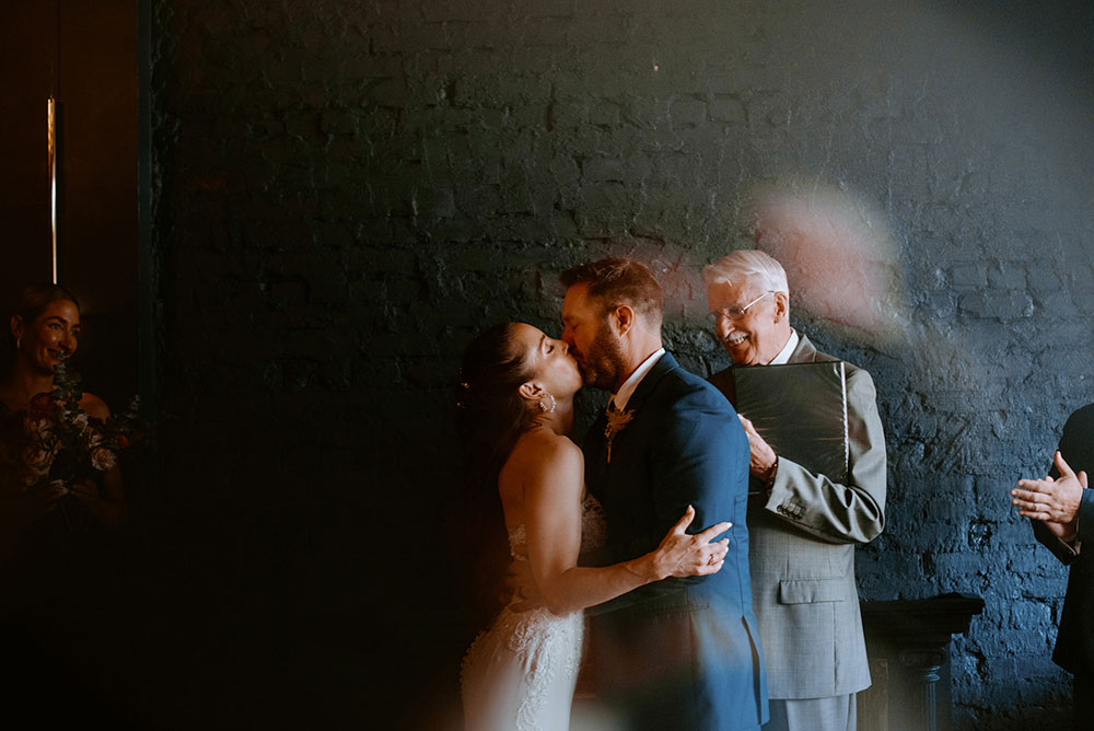 Newlyweds kiss during the ceremony at the cedar nest in Sudbury