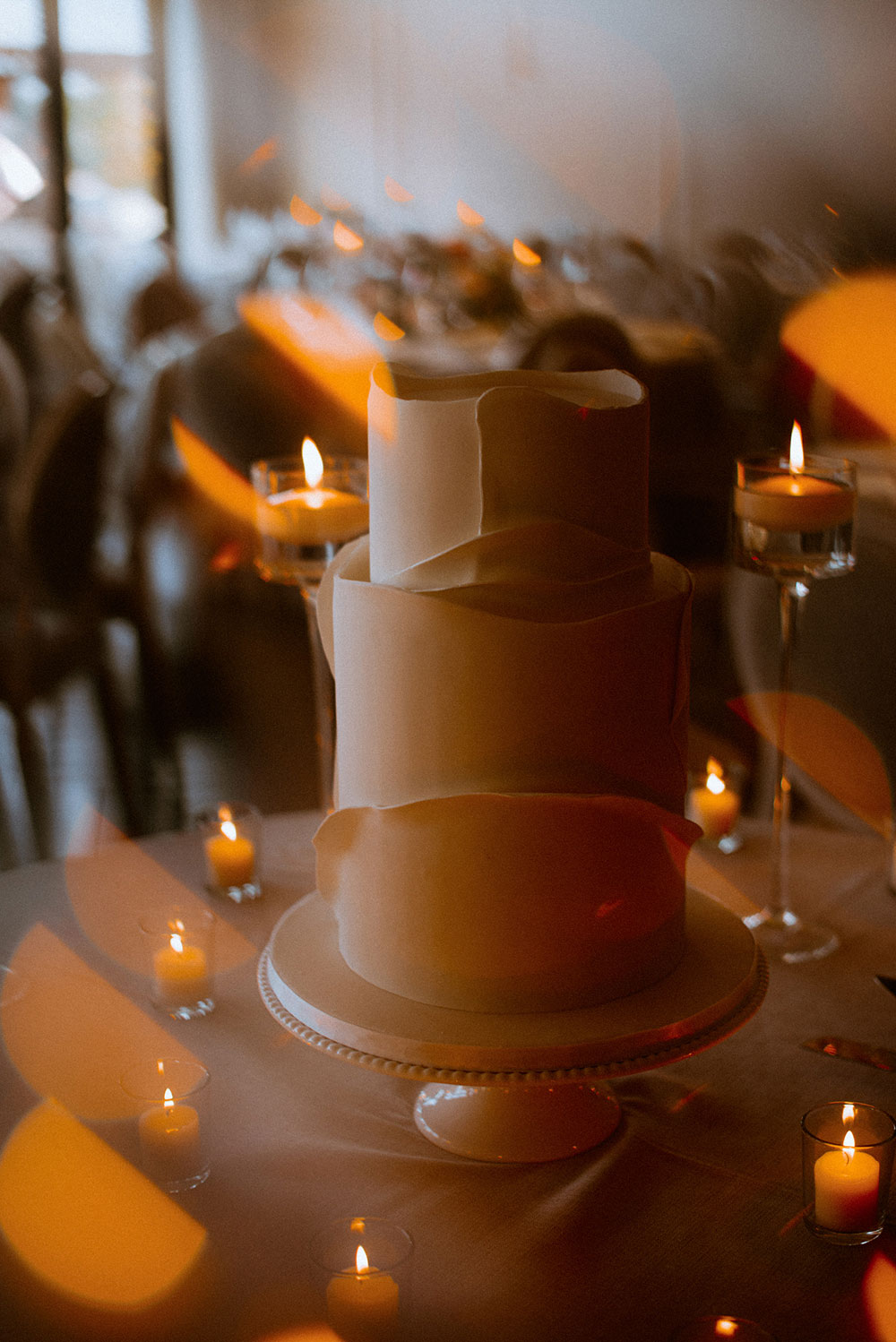 stylish elegant wedding cake surrounded by candlelight at this Arlington Estate wedding