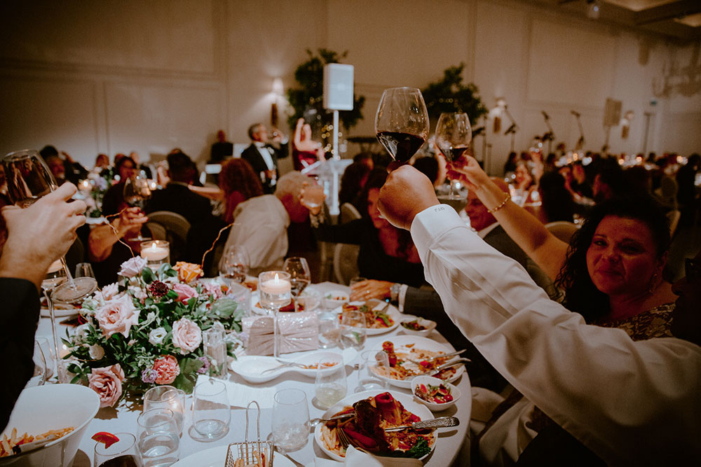 the crowd raises their glasses and cheers during this Arlington Estate wedding