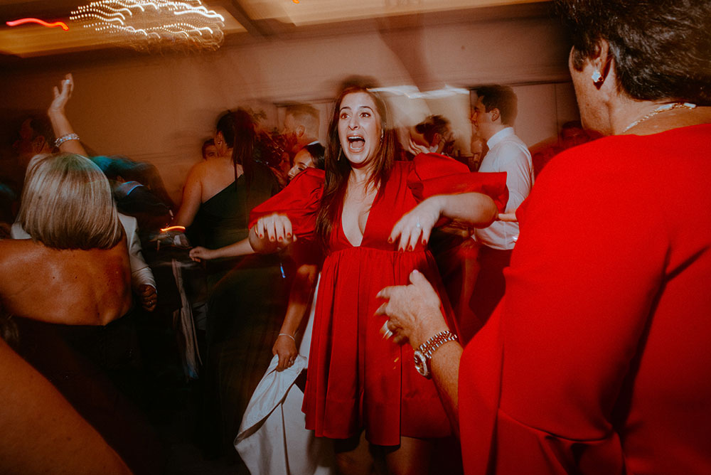 woman in red dress enjoys her time at this Arlington Estate wedding