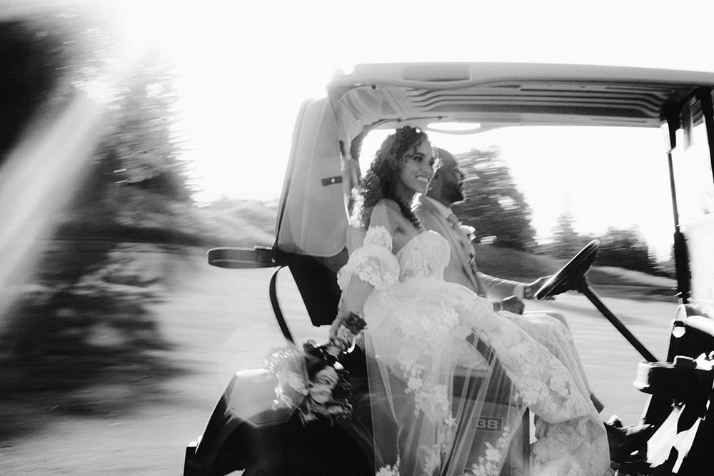 bride and groom drive away on golf cart at this Bayview Golf Wedding