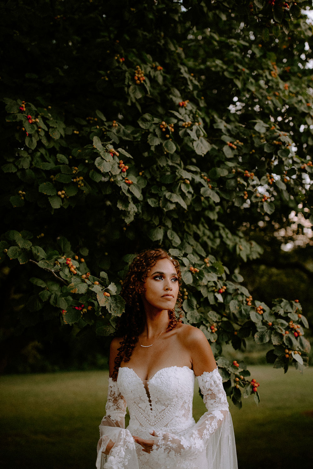 bride poses bya berry tree at this Bayview Golf Wedding