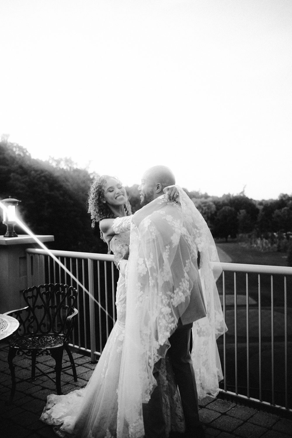 bride and groom kiss on terrace at this Bayview Golf Wedding