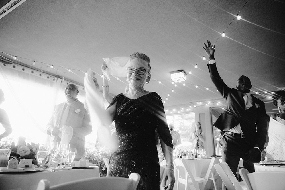 guests wave their napkins and cheers at this Bayview Golf Wedding