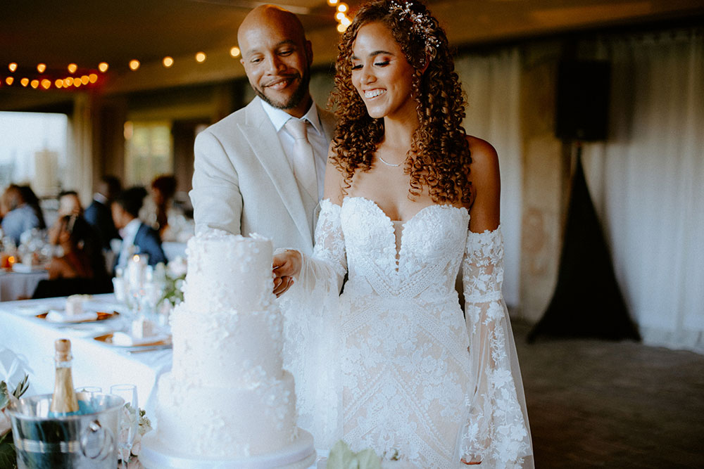 newlyweds cut the cake made by sugar suites cakes at this Bayview Golf Wedding