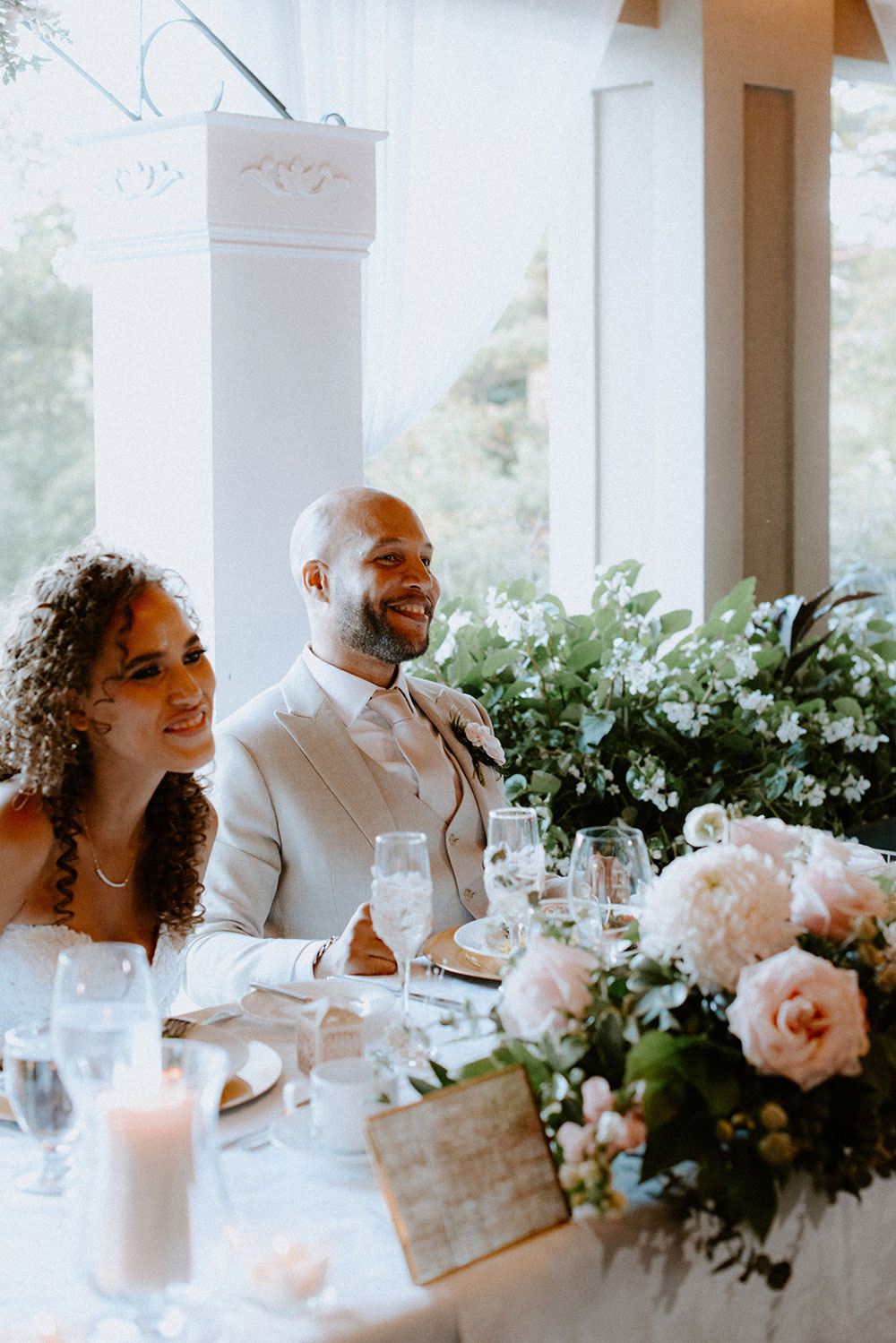 bride and groom listen to speeches at this Bayview Golf Wedding