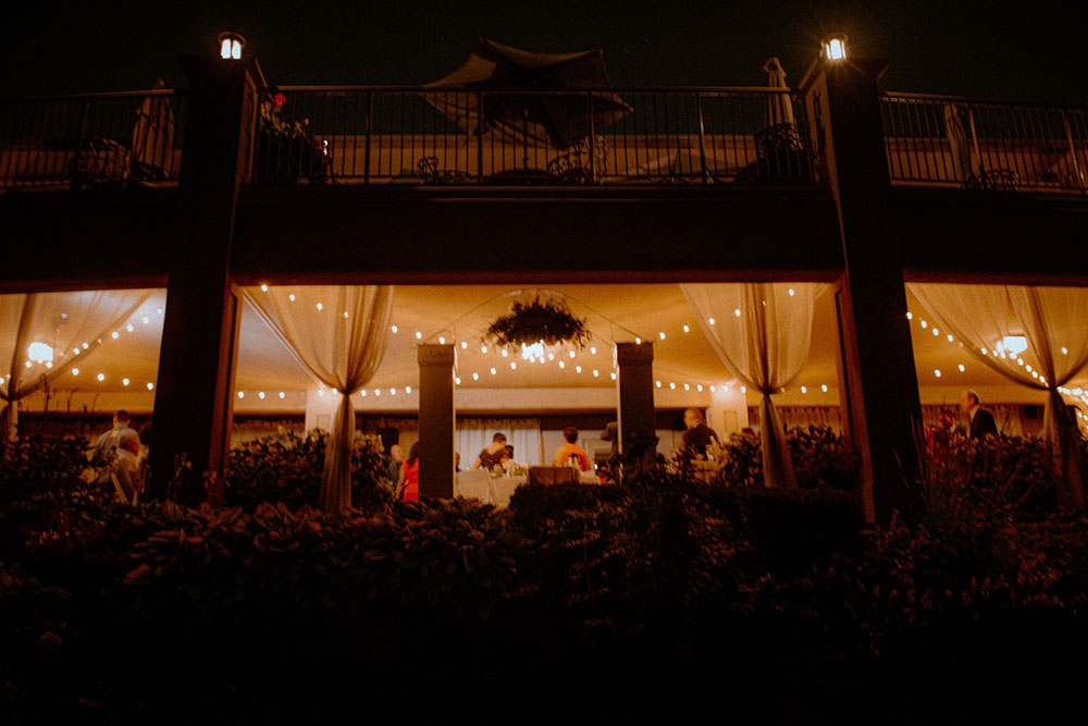 view of the wedding reception at night from afar at this Bayview Golf Wedding