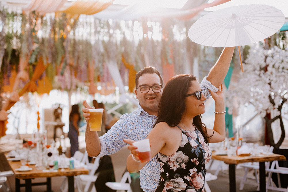 couple dances with drinks in hand at the Catana Estate