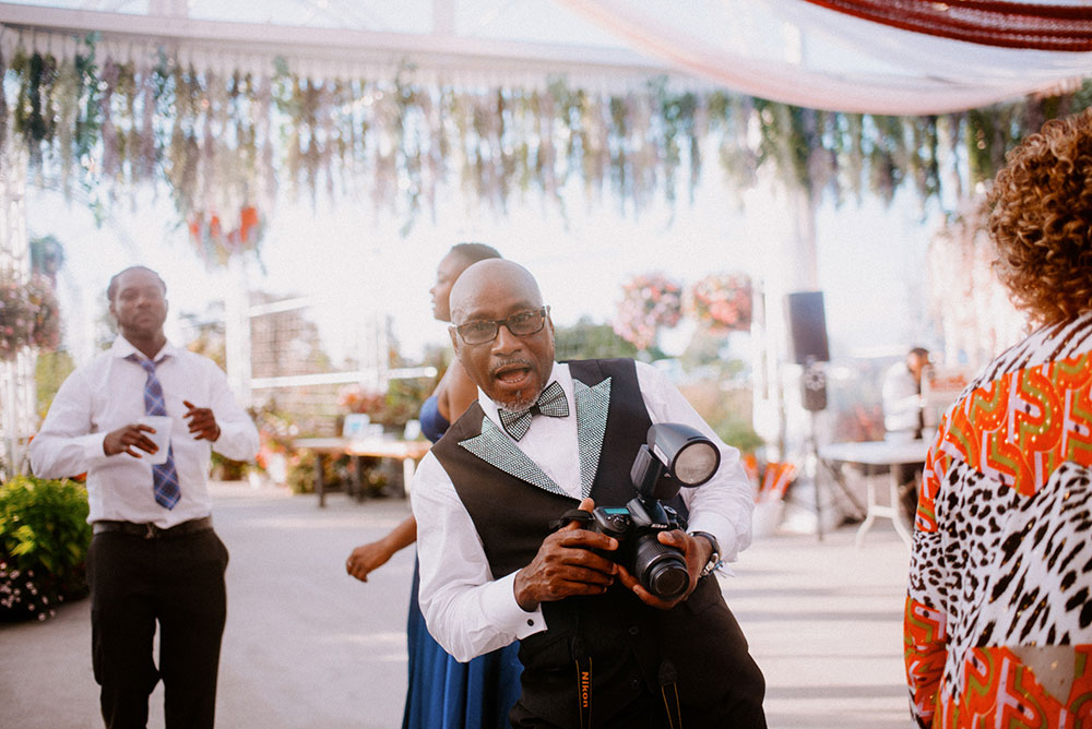 guest poses with his cameras in hand at this Catana Estate wedding