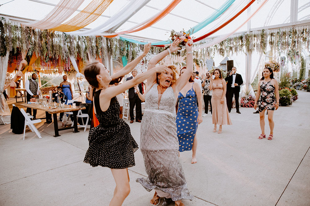 woman catches the bouquet at the Catana Estate wedding