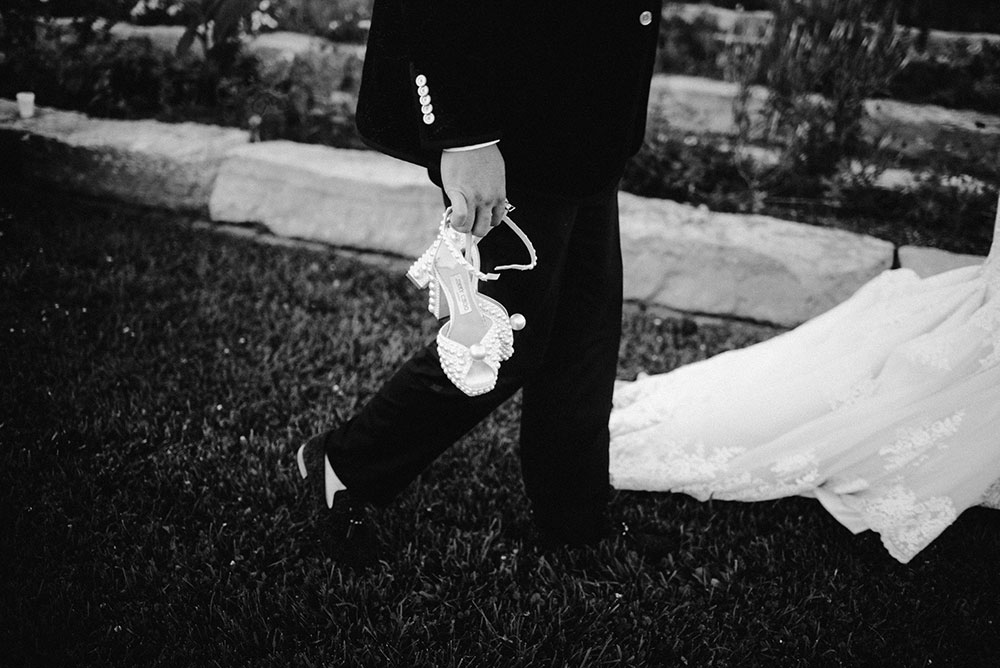 groom holds brides jimmy choo shoe
at the Catana Estate